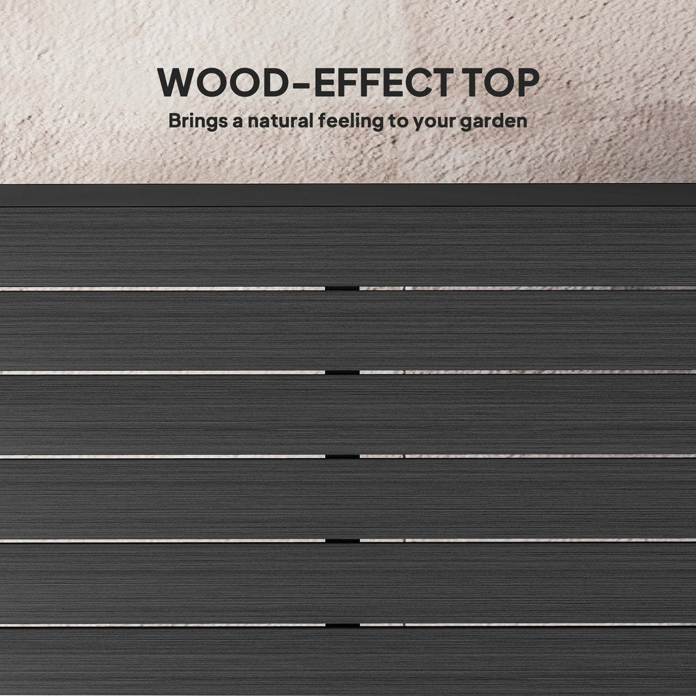 a close up of the slatted surface showing the wood effect texture of the garden table