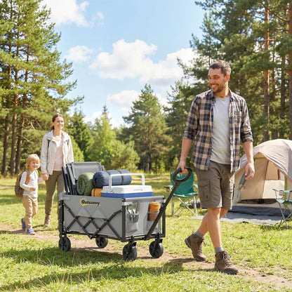 A family using the grey collapsible wagon cart to carry camping gear in a forest setting