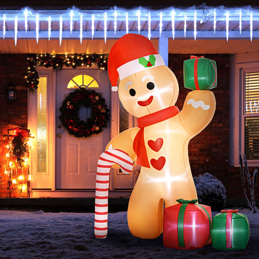 The inflatable gingerbread man decoration in front of a house at night with Christmas lights
