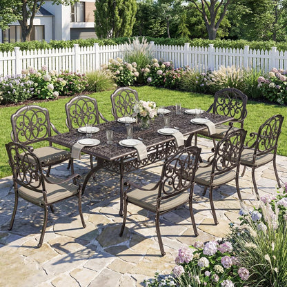 The garden dining set placed on a stone patio in a lush garden with a white picket fence