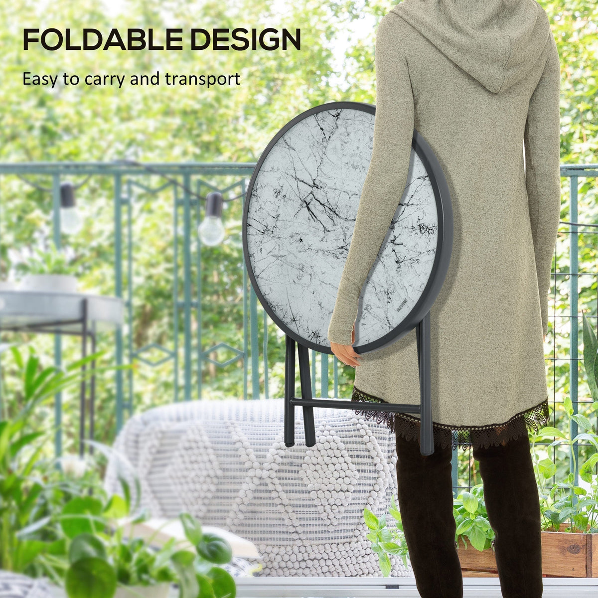 A person holding the folded round garden table, showing its foldable design