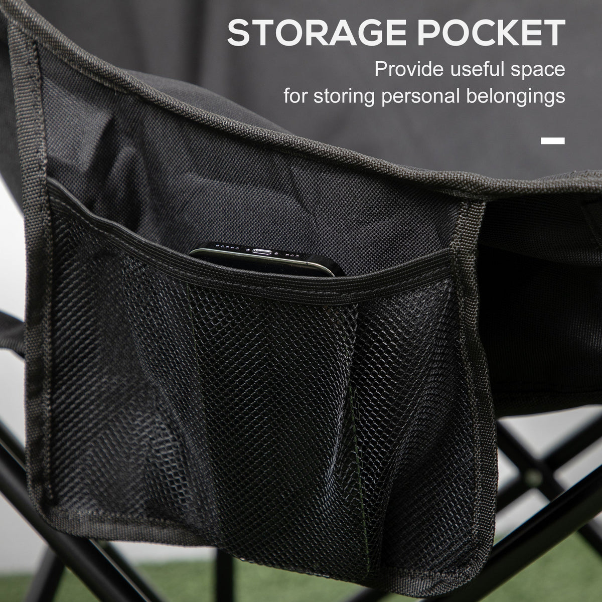 Close-up of the black camping chair showing a mesh storage pocket on the side with a phone inside