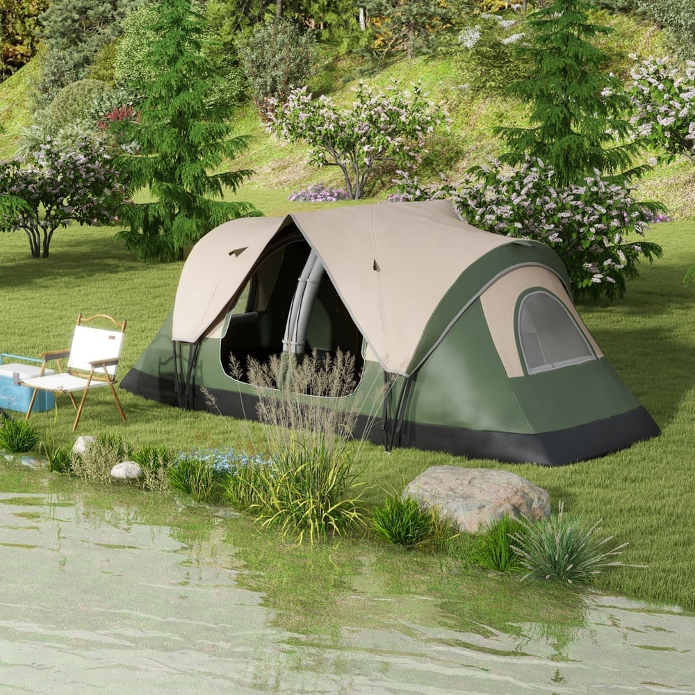 The camping tent set up on a grassy bank by a lake with a folding chair nearby