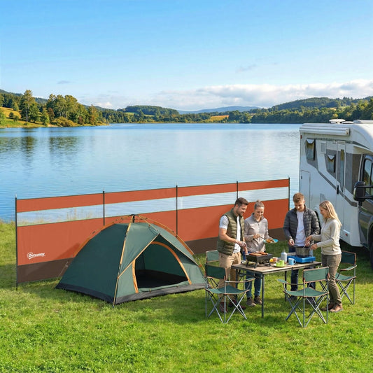The camping windbreaker set up by a lake with a caravan and tent