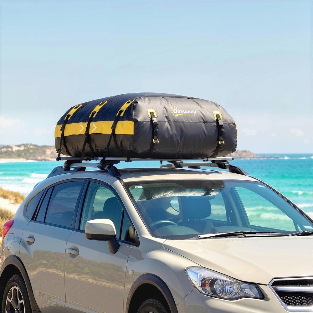 The waterproof car roof bag secured to the roof rack of a car on a beach