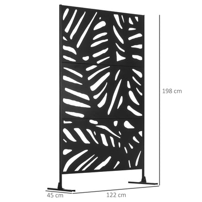 A black metal garden privacy screen with a leaf pattern standing on a patio