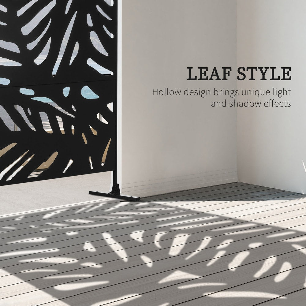 The decorative metal outdoor divider casting leaf-shaped shadows on a wooden deck