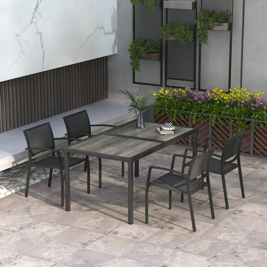 The garden dining set in a patio setting with plants and modern wall feature