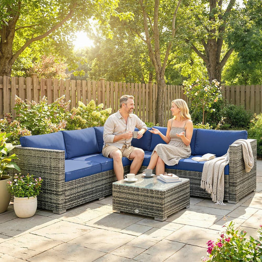 the garden sofa set arranged on a patio with a couple sitting and talking together