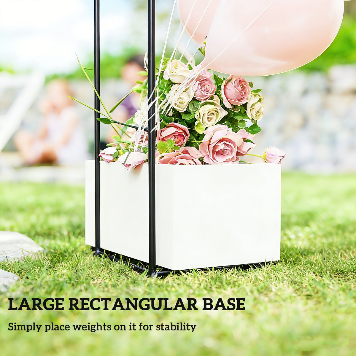 A white rectangular base for the garden arch, holding balloons and flowers