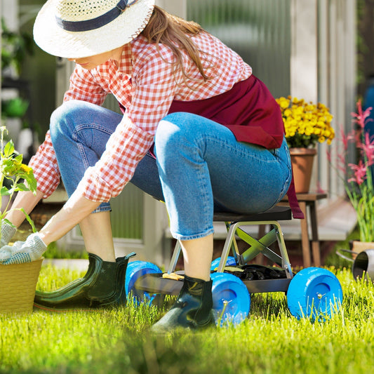 the garden trolley being used as a seat by a person working in a sunny garden