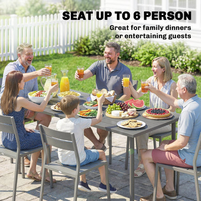 A family and friends enjoying a meal at a rectangular outdoor dining table in a garden setting