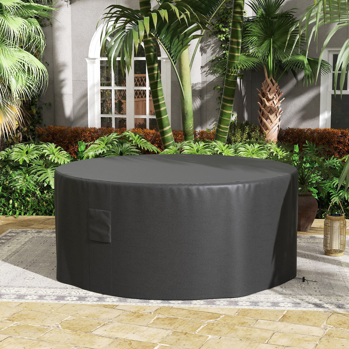 The large round garden furniture cover is shown protecting a patio set outdoors
