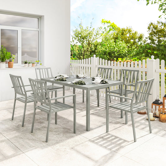 The garden dining set arranged on a patio with place settings on the table