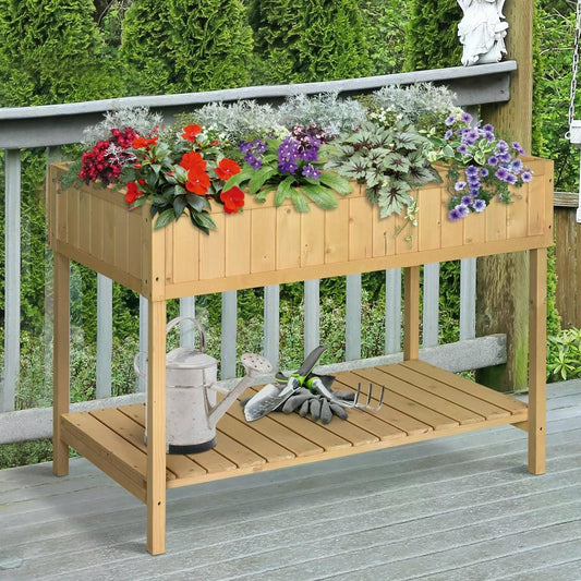 The wooden plant stand placed on a deck with gardening tools and a watering can on the lower shelf