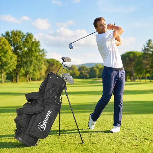 A man is playing golf with the golf stand bag beside him on a sunny golf course