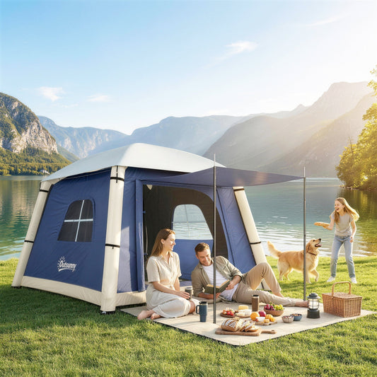 The dark blue camping tent set up in a grassy area by a lake with people relaxing outside