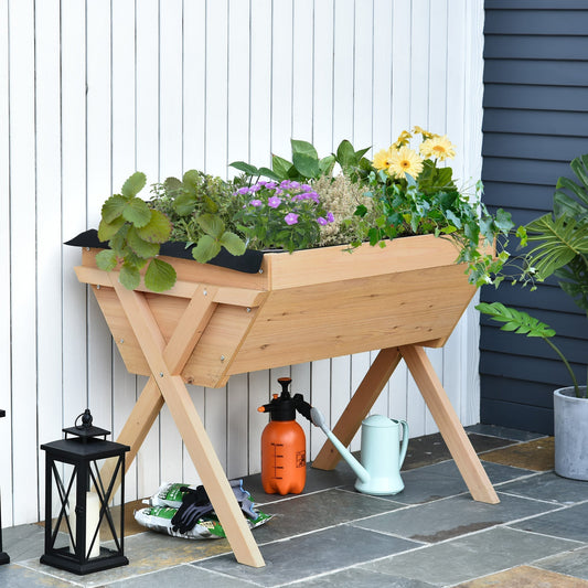Raised garden bed with plants on a patio next to a lantern and watering can