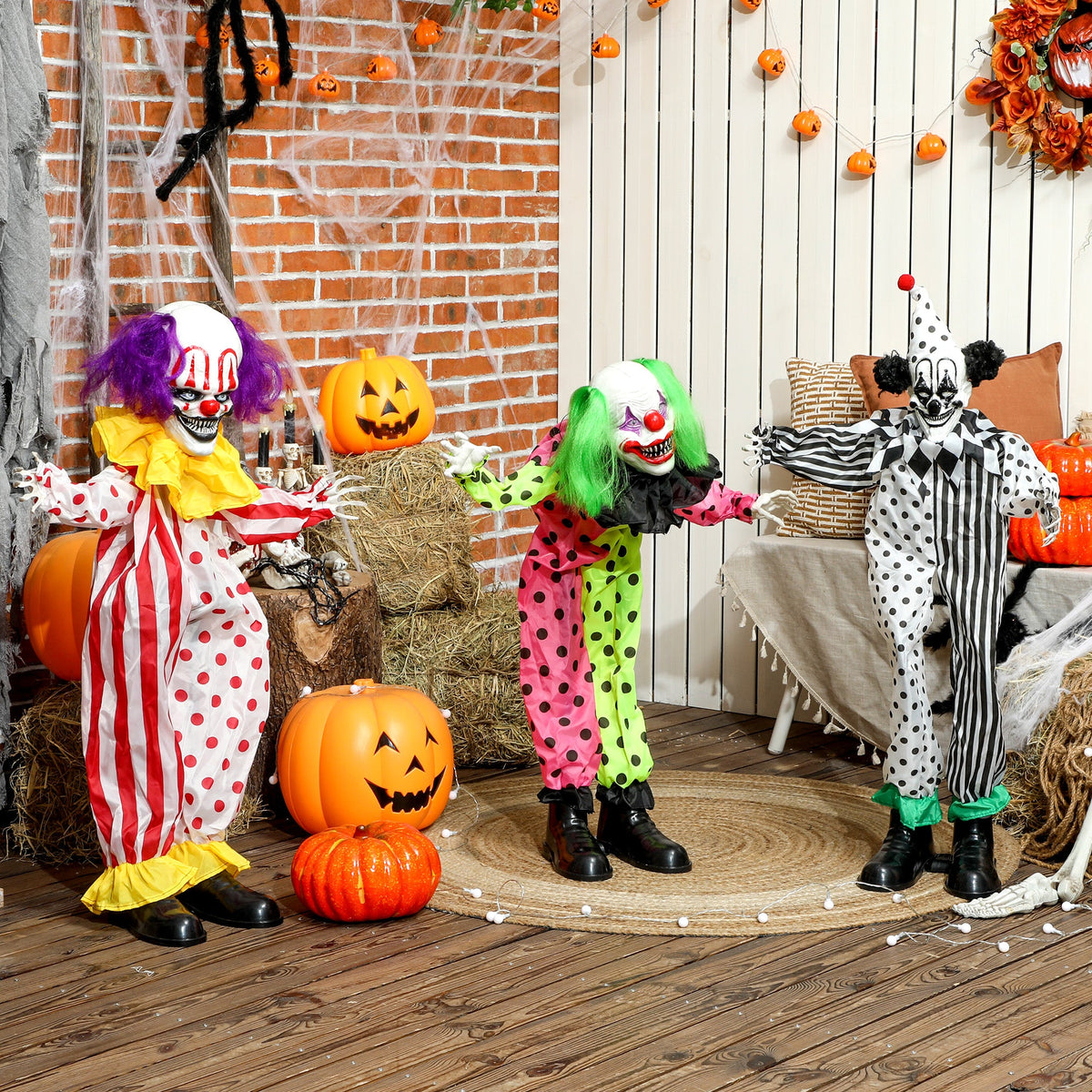 Three scary clowns arranged in a room with Halloween decorations