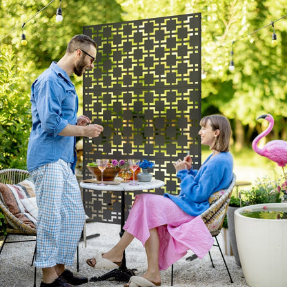 The decorative privacy screen used outdoors to divide a patio area with a table and chairs