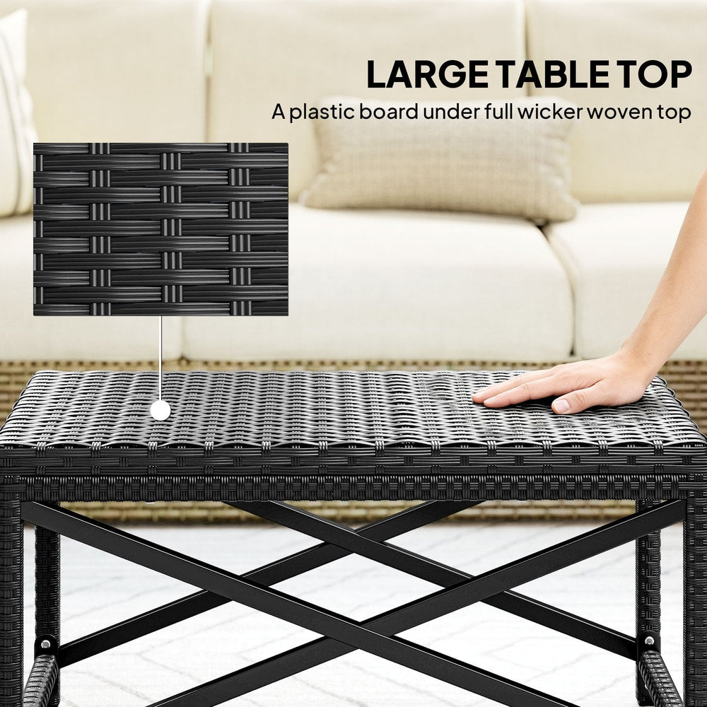 A hand touches the woven top of the coffee table, showing the plastic board underneath