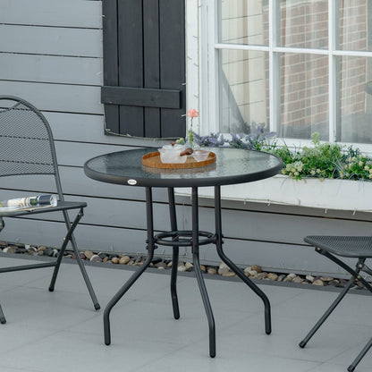 The garden table set up on a patio with chairs and a small tray for outdoor dining