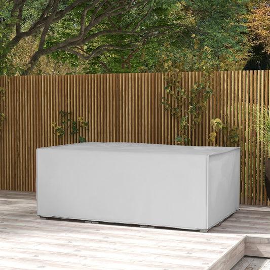 The grey rectangular patio furniture cover is shown on a table on a wooden deck