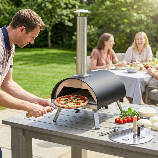 The charcoal grill being used by a man to slide a fresh pizza into the oven on a garden table