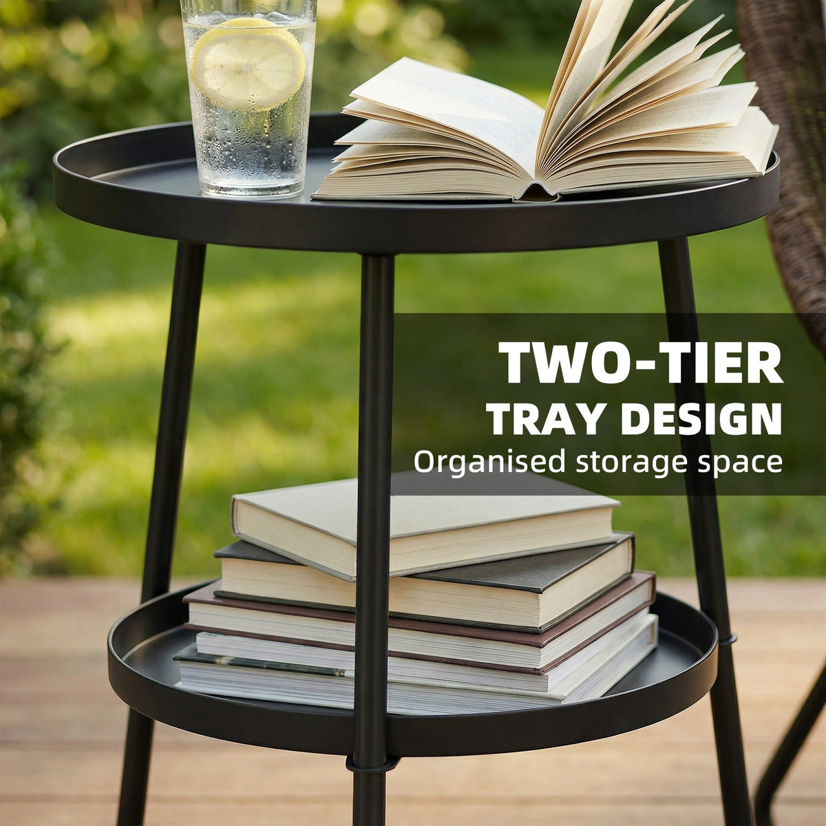 A black two-tier round coffee end table with books and a drink on it