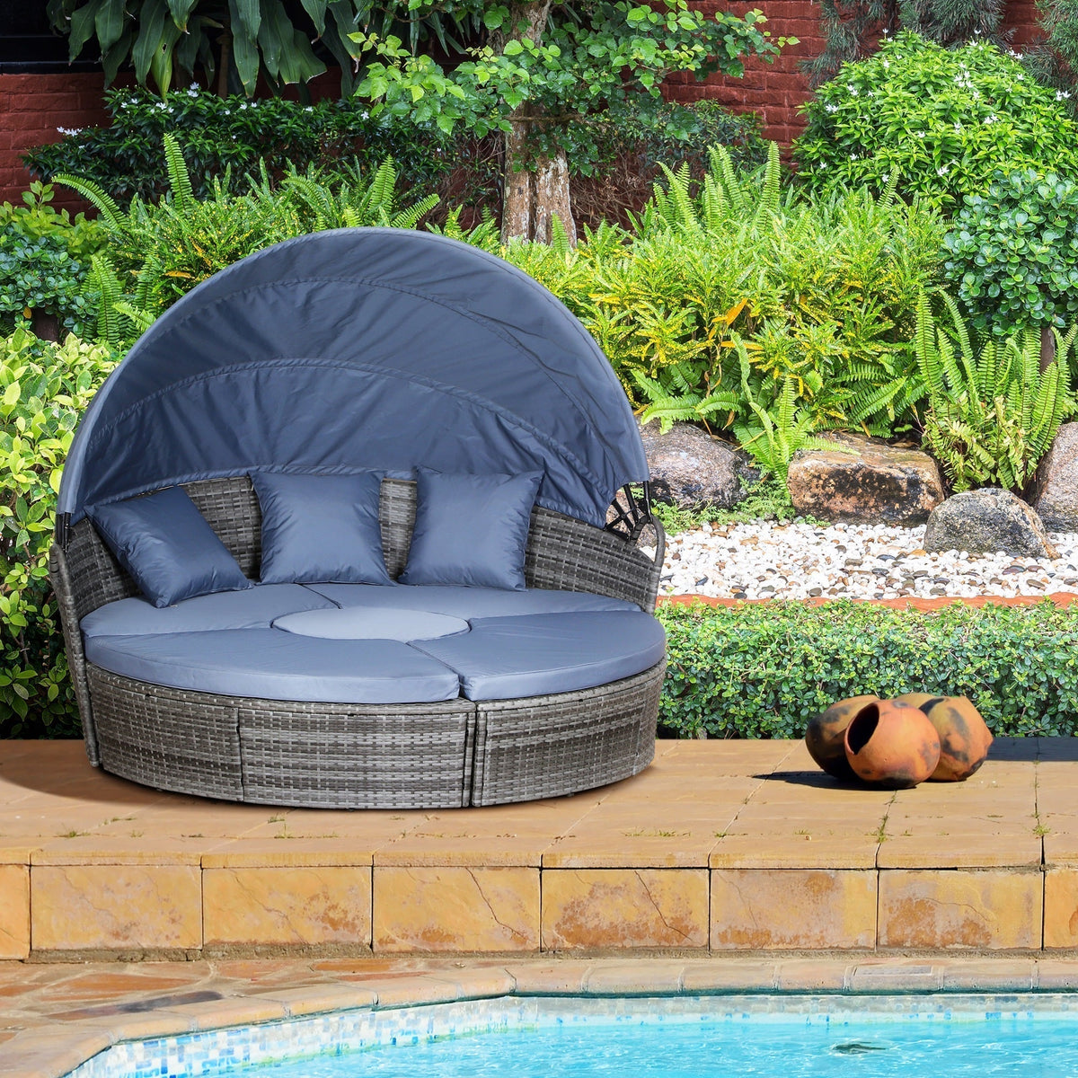 The rattan furniture set placed on a patio beside a swimming pool in a garden setting