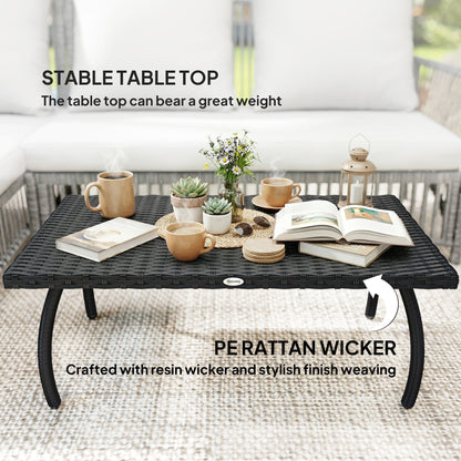 The garden table surface with coffee cups and books showing the stable top and woven texture