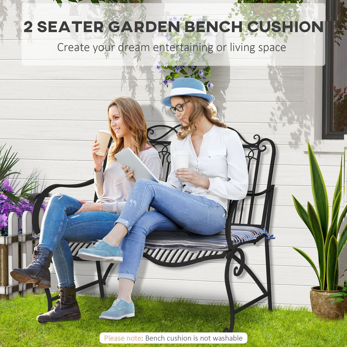 Two women sitting on a garden bench with striped cushions