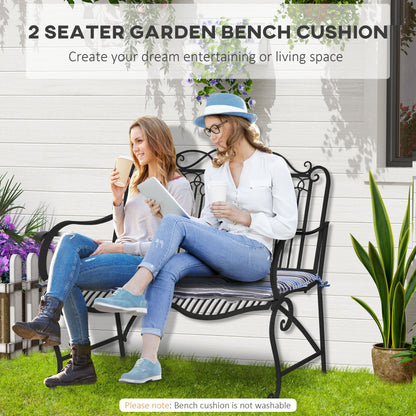 Two women sitting on a garden bench with striped cushions