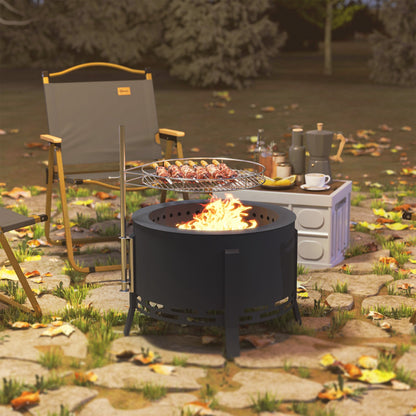 The fire pit set up in a garden with a camping chair and table in the background