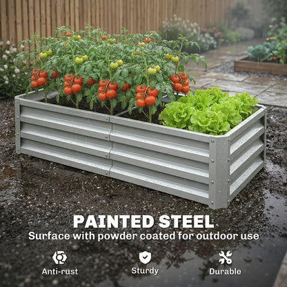 The garden planter filled with tomato plants and lettuce during a light rain shower