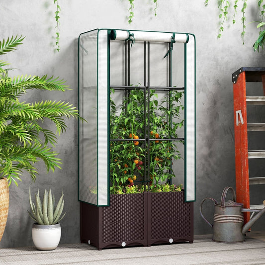The raised garden bed with trellis in use, growing tomato plants inside a greenhouse cover