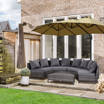 The rattan garden sofa set arranged on a patio with a large umbrella overhead