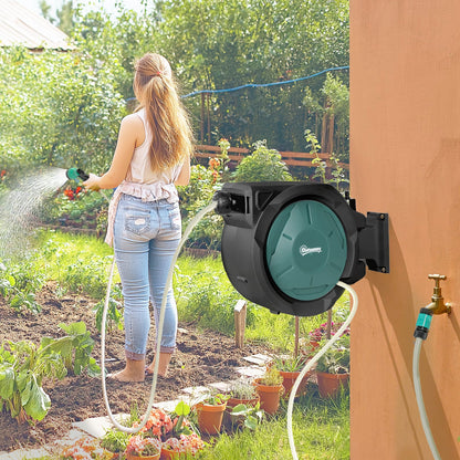 The garden hose reel in use watering plants in a sunny garden setting