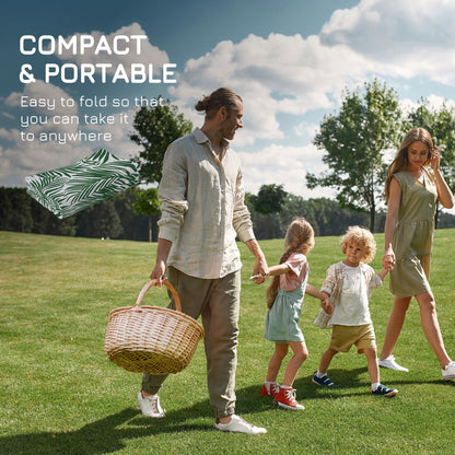 A family carrying the folded outdoor rug for a picnic