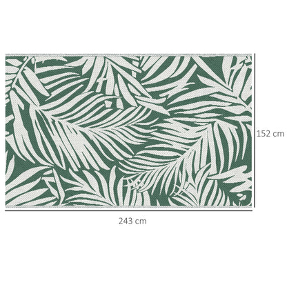The reversible outdoor rug shows a green leaf pattern on a white background