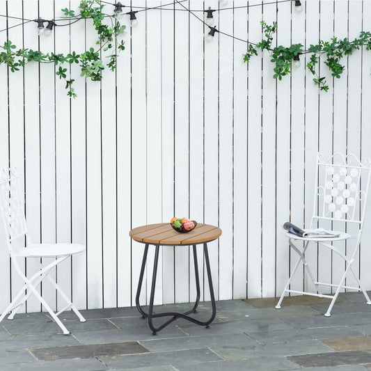 The garden table is set up on a patio with two white chairs and decorative lights