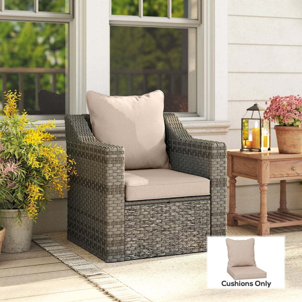 Beige garden chair cushions on a grey rattan chair on a patio
