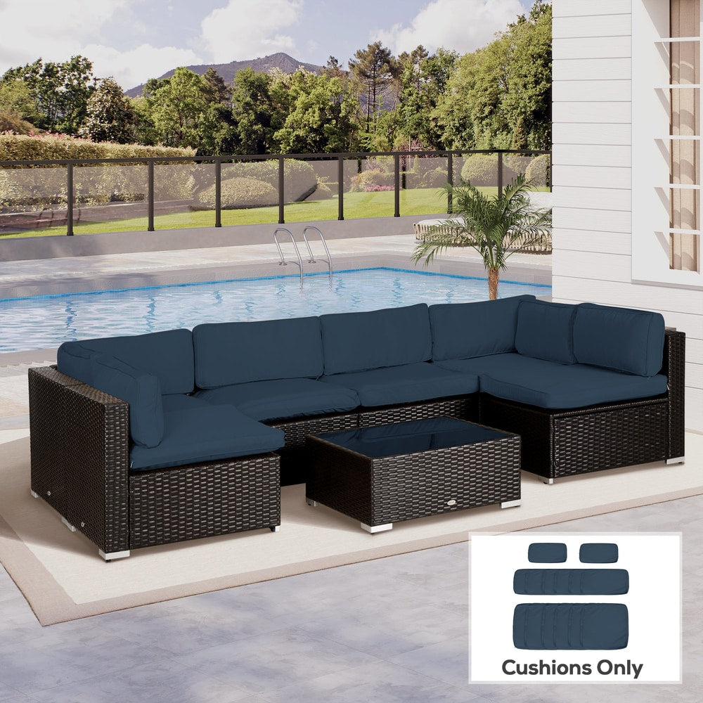 Blue cushion covers on a large outdoor rattan furniture set with a swimming pool in the background