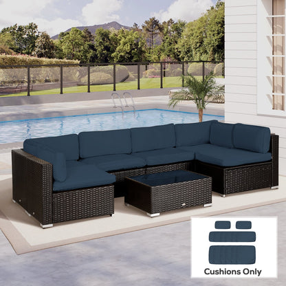 Blue cushion covers on a large outdoor rattan furniture set with a swimming pool in the background