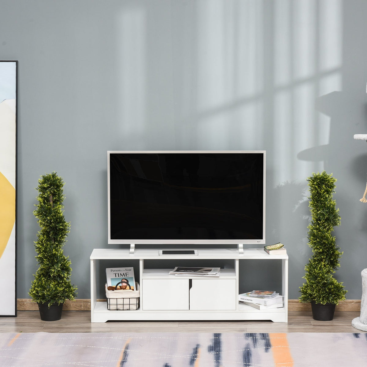 Two artificial plants flanking a television stand in a living room setting