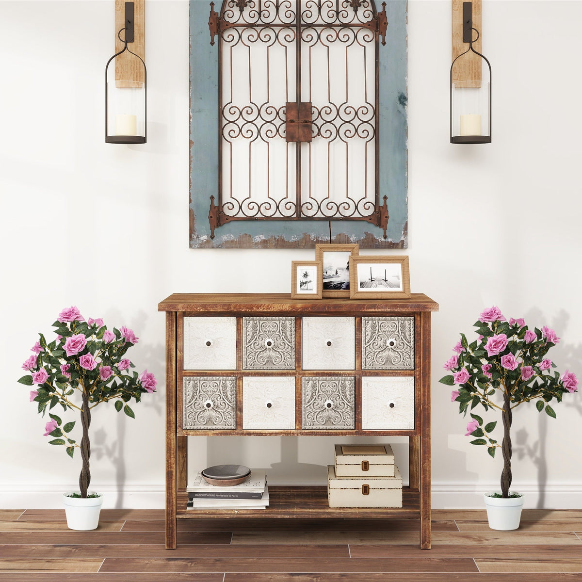 The artificial plants displayed on either side of a wooden sideboard in a hallway