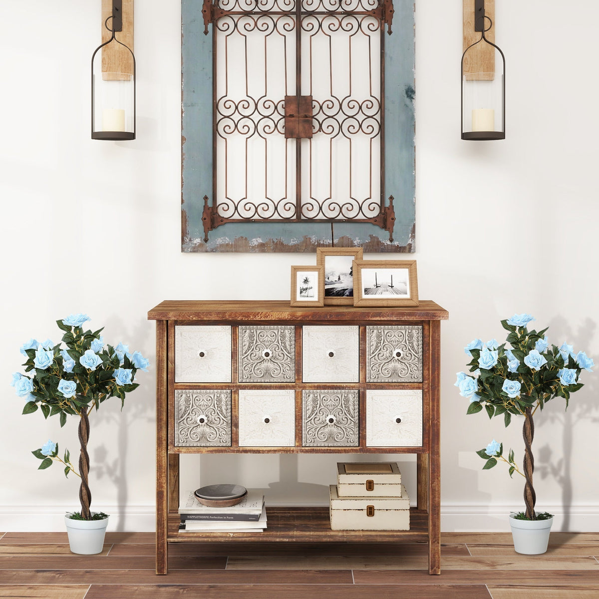 The artificial plants standing on either side of a wooden cabinet in a hallway