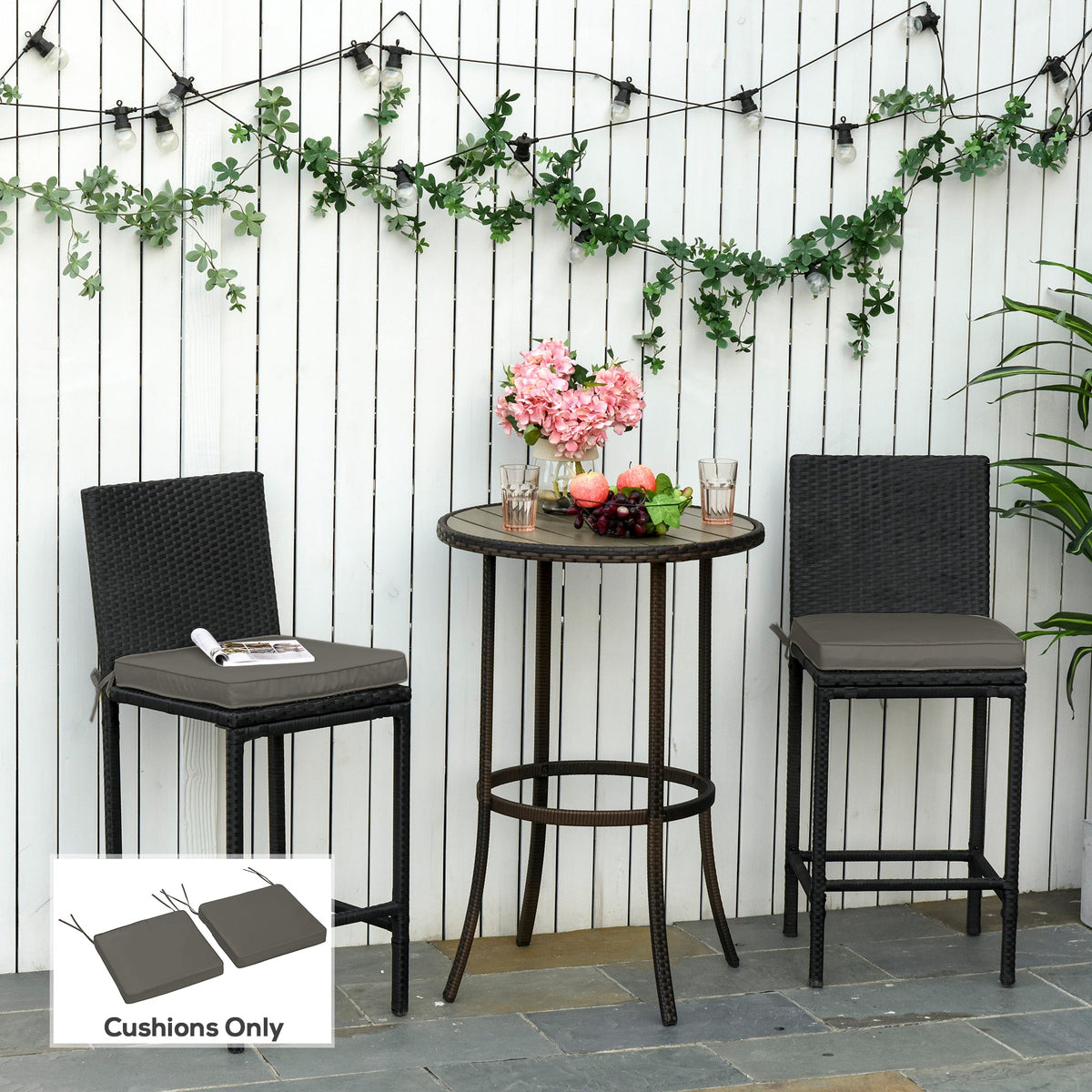 Two dark grey chair cushions on outdoor bar stools next to a table