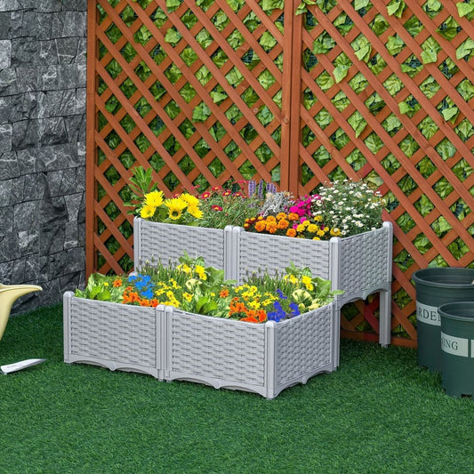 Four grey woven effect raised garden beds filled with colourful flowers in a garden setting