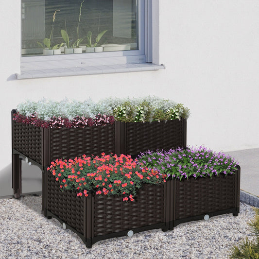 Four brown raised garden beds with flowers on a patio